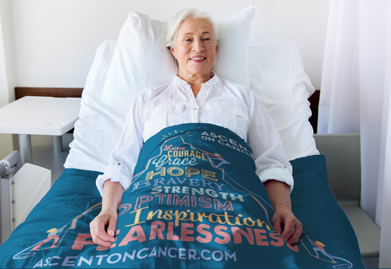 Patient in hospital bed covered with blue blanket